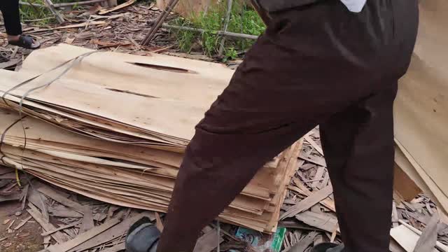 Worker Lifting Veneer Stack
