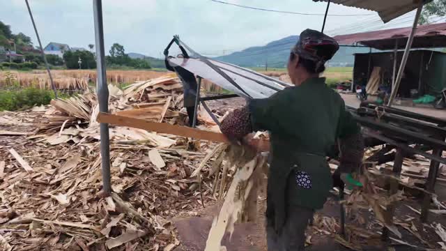 Worker Carrying Wood Offcuts