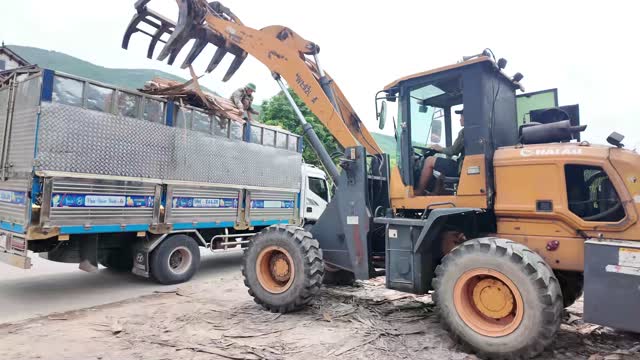 Loader Grapple Beside Truck