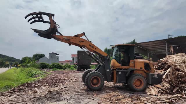 Loader Lifting Wood Scrap