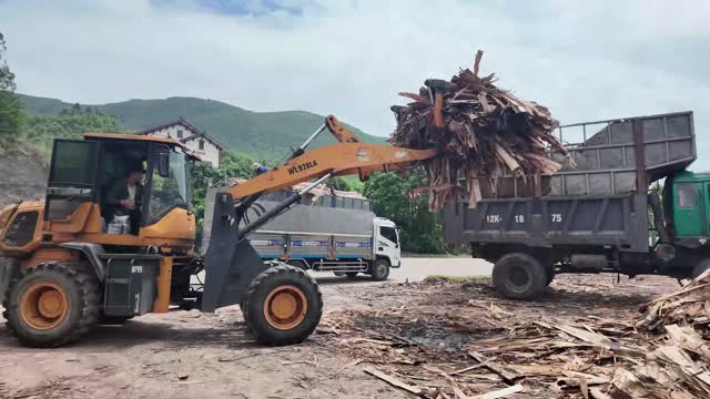 Grapple Dumping Timber Waste