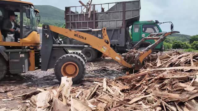 Loader Pushing Wood Scrap