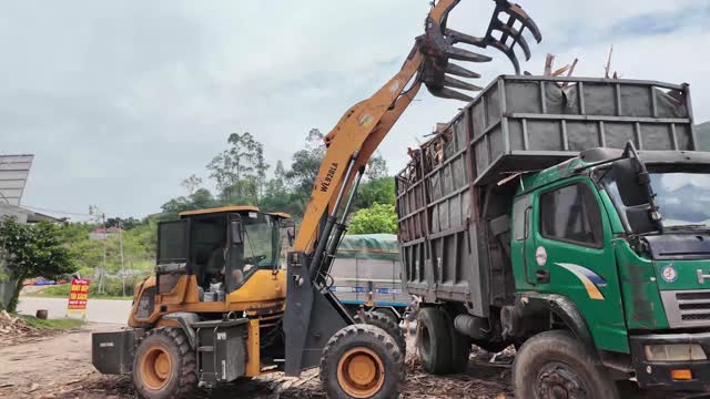 Grapple Loading Under Clouds