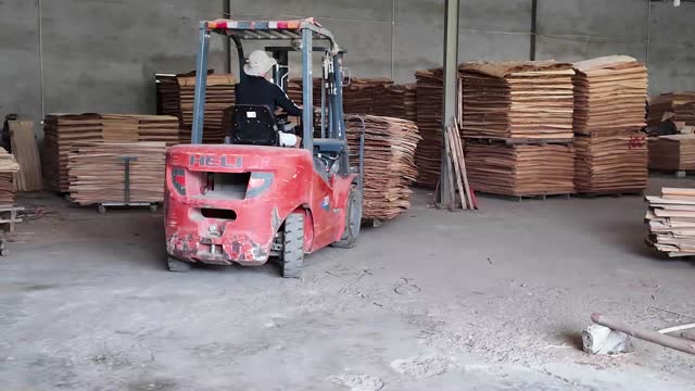 Forklift Moves Through Warehouse