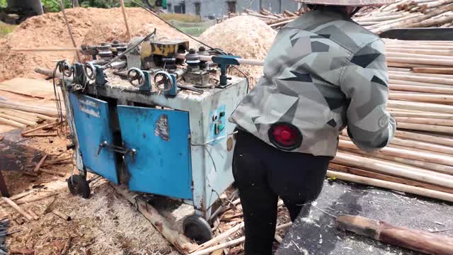 Worker At Timber Rounding Machine