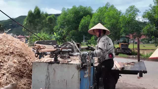 Worker At Wood Rounding Machine