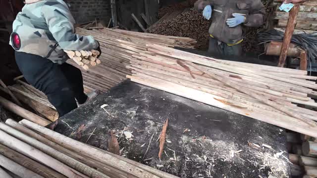Workers Sorting Wooden Sticks