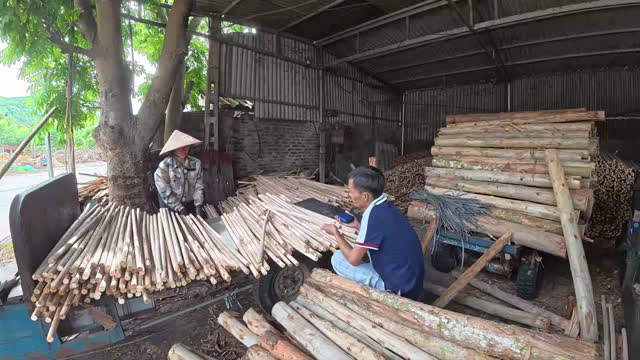 Two Workers In Timber Shed