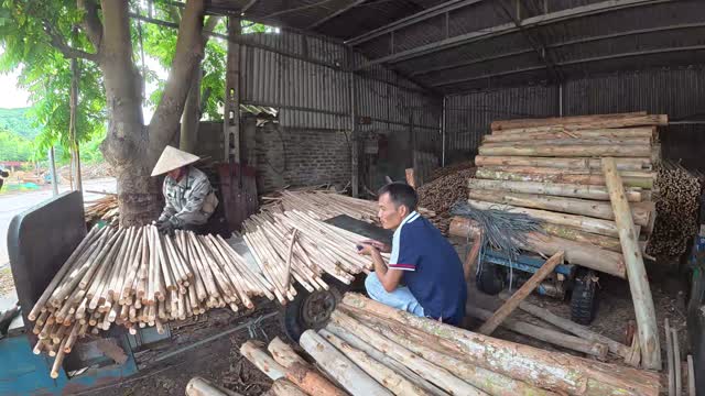 Workers Beside Wooden Poles