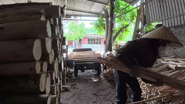 Worker Gathering Wooden Planks