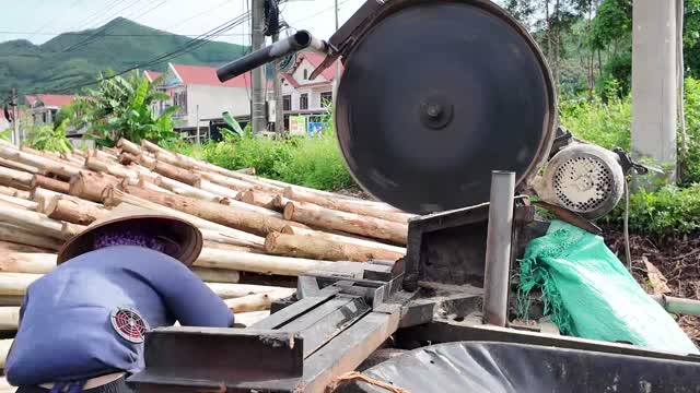 Worker At Circular Saw Machine