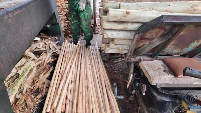Worker Among Wooden Dowels