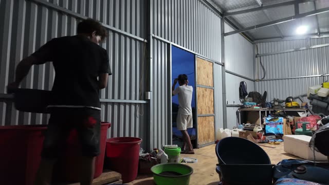 Scooping Fish Feed Pellets