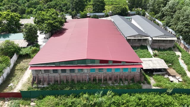 Red Barn Beside Grey Sheds