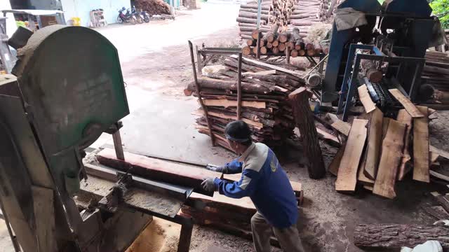 Pushing Log Through Sawmill