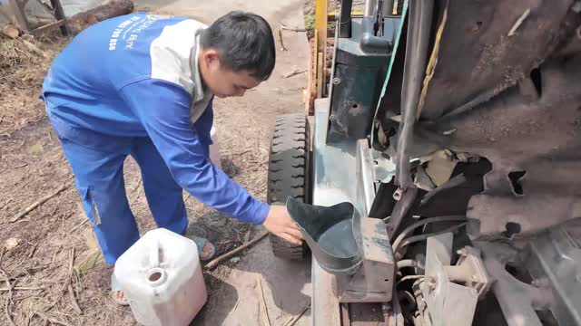 Worker Refueling The Forklift