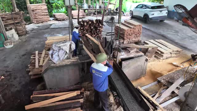 Workers Loading Saw Machine