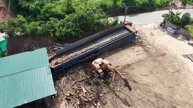 Excavator Sorting Wood At Conveyor