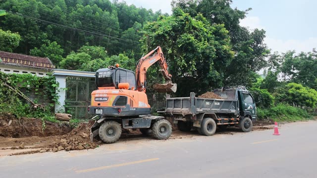 Excavator Breaking Rock Wall