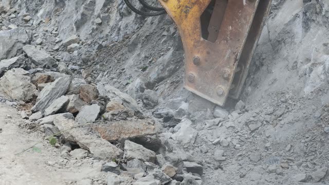 Hydraulic Breaker Smashing Rock
