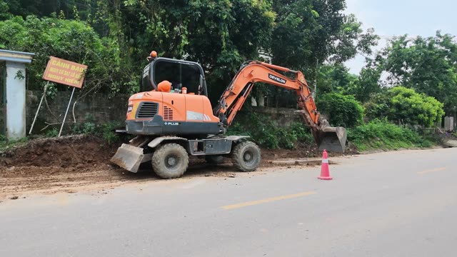 Excavator Breaking Rock Wall