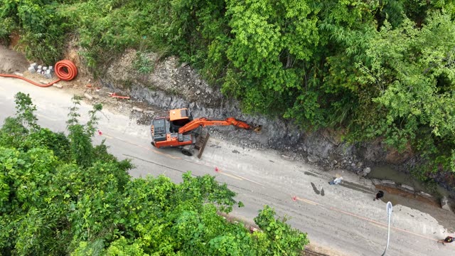 Excavator Working By Mountain Road