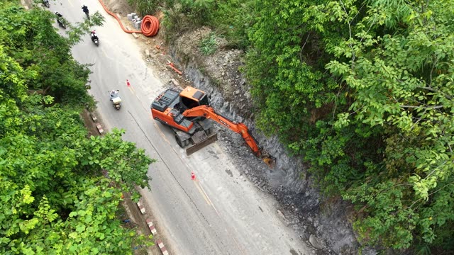 Excavator Clearing Rockslide Debris