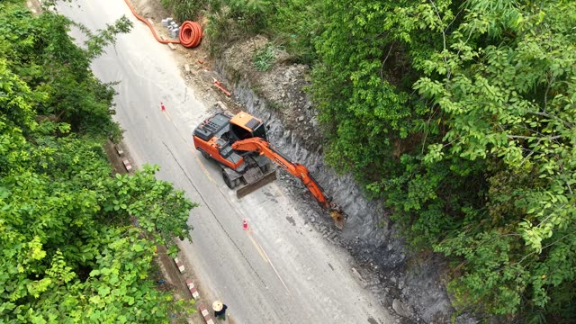 Excavator Digging Beside Forest Road