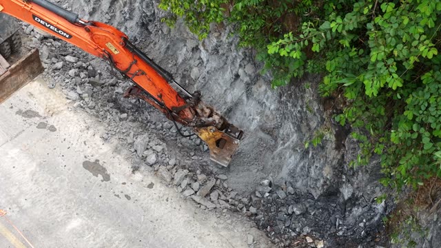 Excavator Bucket Digging Rock