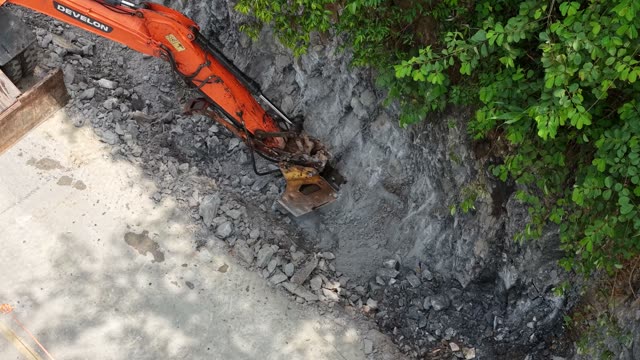 Excavator Bucket In Rocky Slope