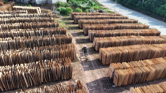 Worker Walking Through Bark Yard