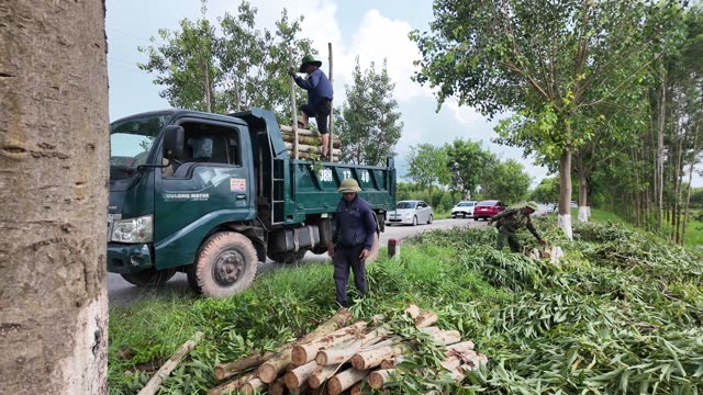 Workers Beside Loaded Farm Truck