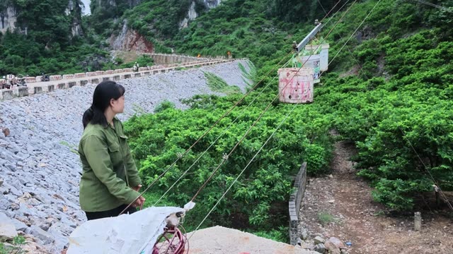 Woman Overlooking Riprap Mountain Road