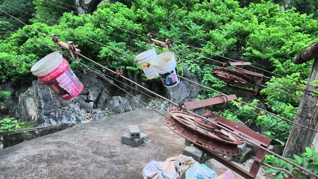 Buckets Hanging On Rusty Cable Pulley
