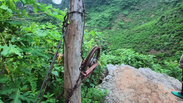 Woman Watching Basket Descend Cable