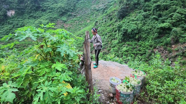 Woman Standing At Cliff Edge With Buckets