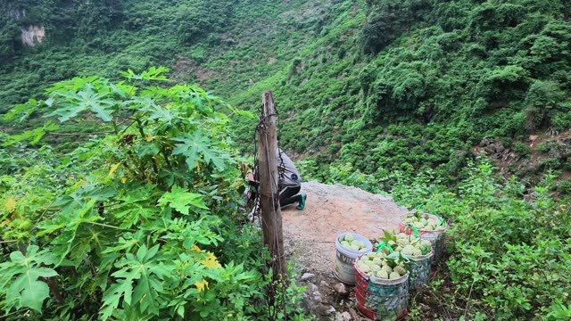 Woman Crouching Near Buckets On Ledge