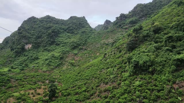 Sweeping Mountain Valley Under Cloudy Sky