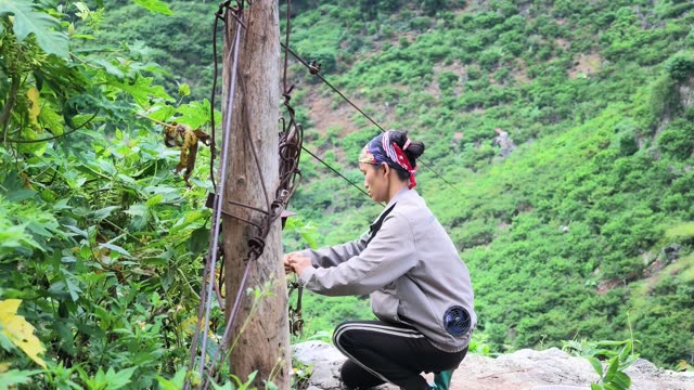 Woman Tying Rope At Cable Post