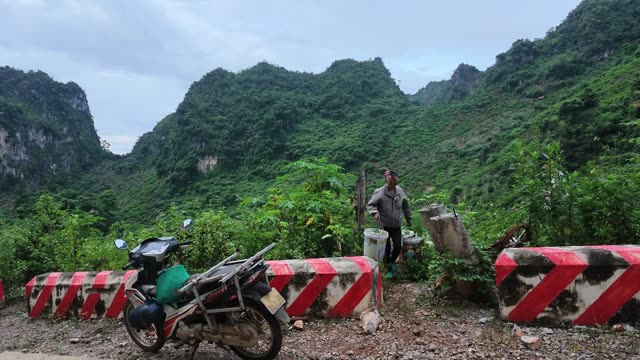 Man Beside Road Barriers And Bucket