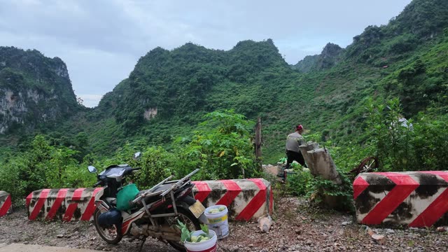 Man Crouching Near Road Barrier