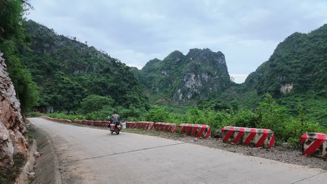Motorbike Riding Down Mountain Road