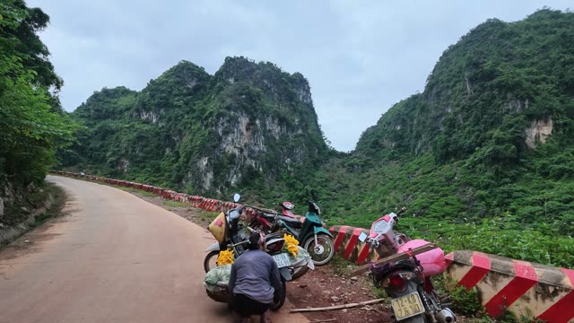 Woman Crouching By Parked Motorbikes