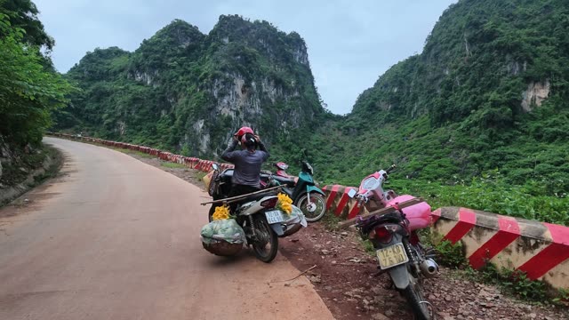 Man Adjusting Helmet On Motorbike