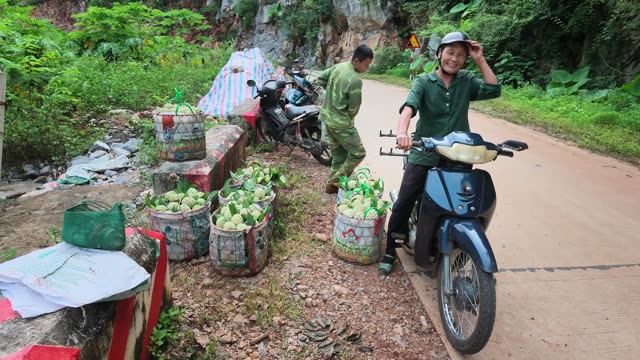 Man Helping Load Basket On Motorbike