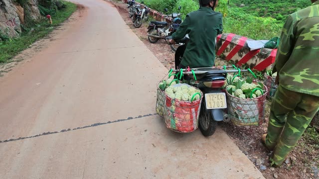 Man Riding Motorbike Loaded With Baskets