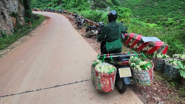 Man Loading Basket Beside Parked Motorbike