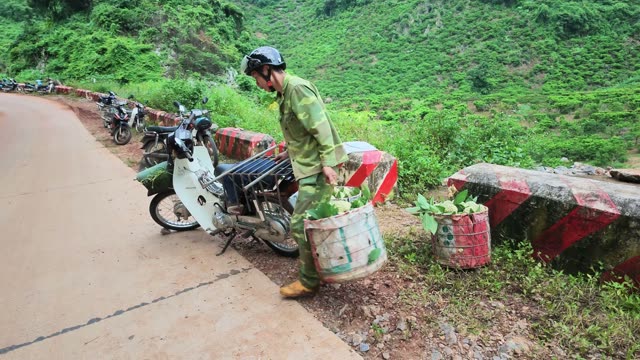 Man Walking With Basket Beside Motorbikes