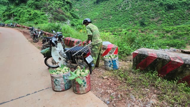 Man Arranging Basket On Loaded Motorbike