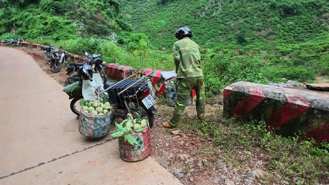 Man Carrying Basket Along Mountain Road